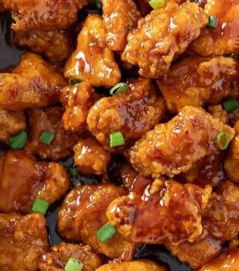 Delicious plate of Firecracker Chicken garnished with vegetables