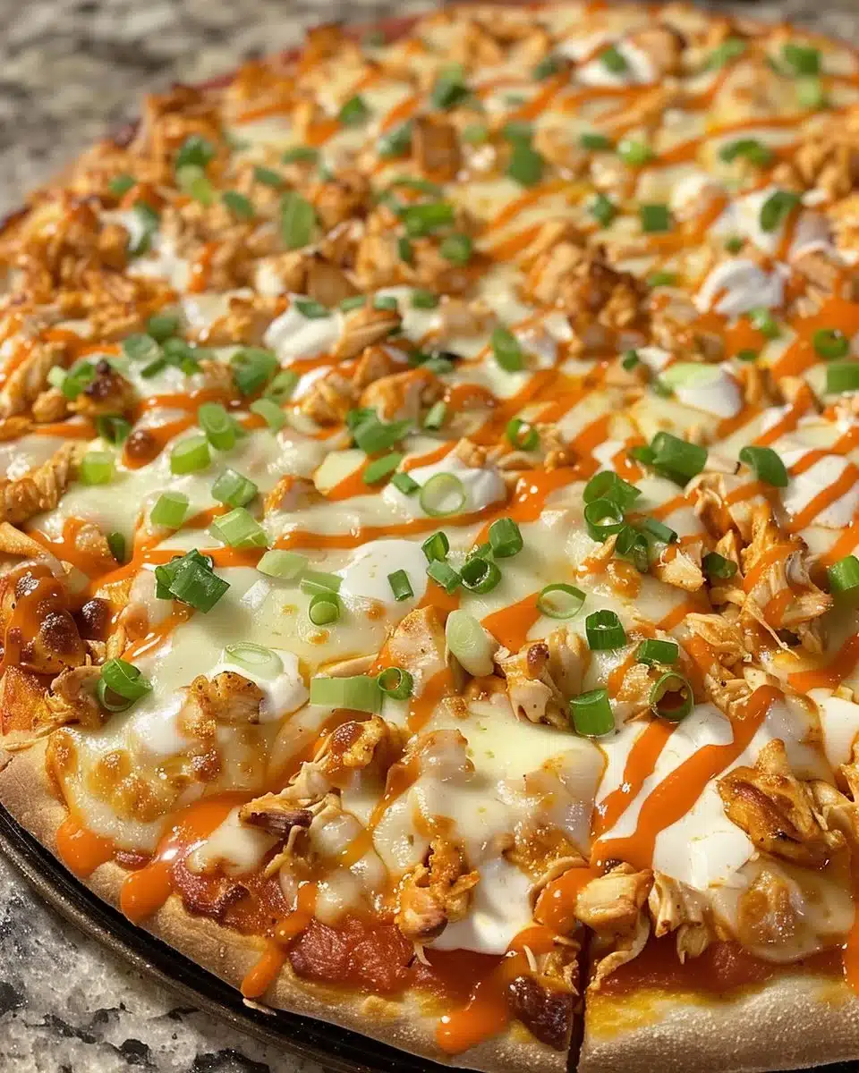 Delicious Buffalo Chicken Pizza topped with spicy sauce and cheese.