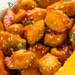 Delicious plate of Orange Chicken served with rice and vegetables