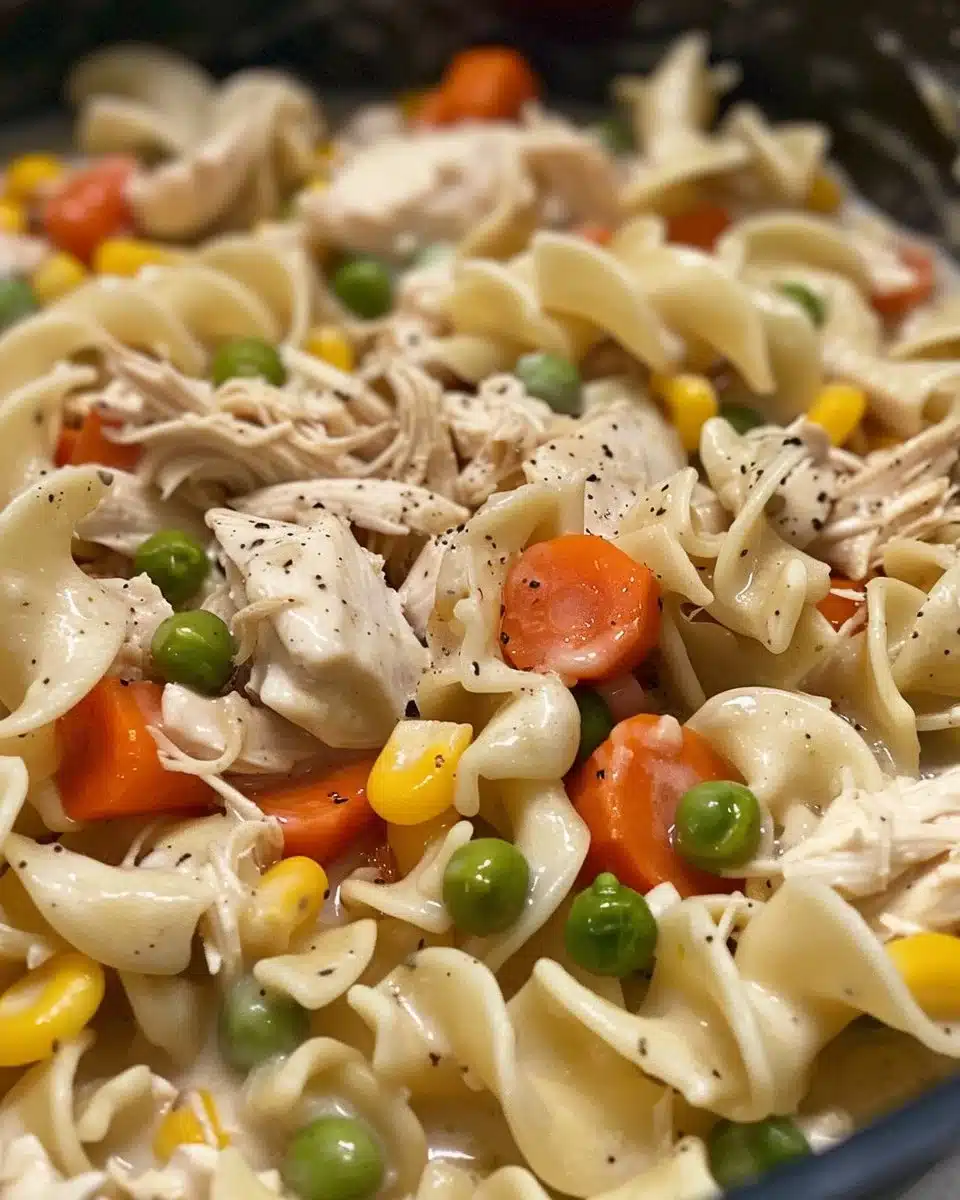 Bowl of easy chicken and noodles with vegetables and herbs