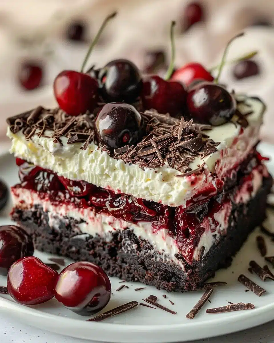 Mini cherry cheesecake brownies topped with fresh cherries and cream cheese layer