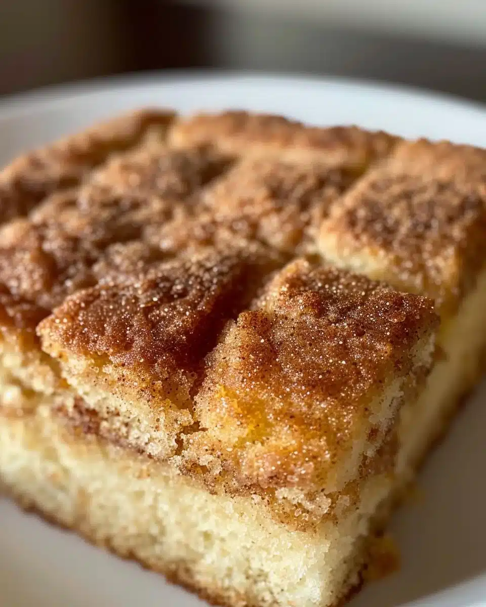 Delicious snickerdoodle layer cake topped with cinnamon sugar