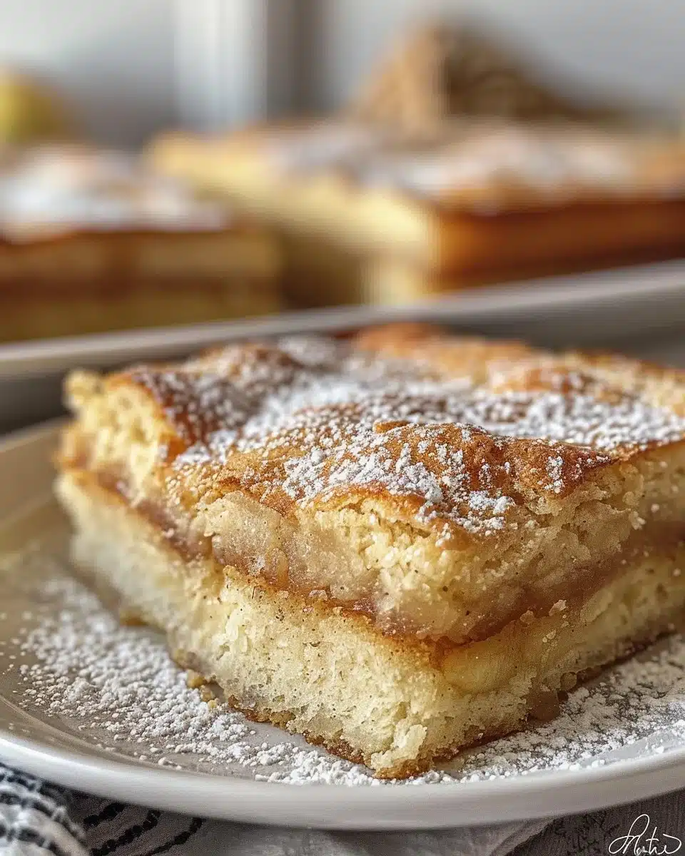 Fluffy apple yogurt pancakes topped with fresh apples and syrup