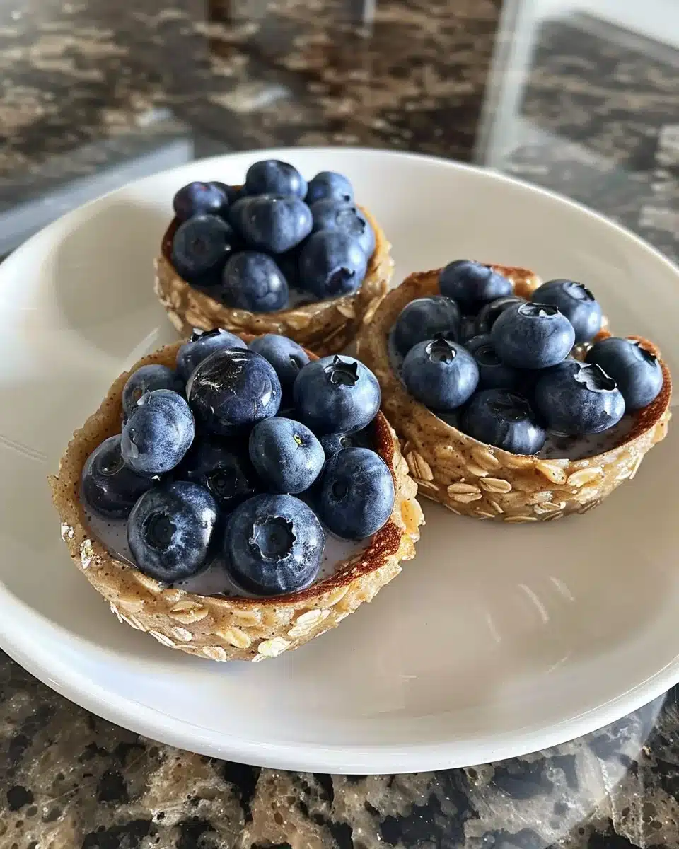 Baked blueberry oats topped with fresh blueberries and a sprinkle of oats