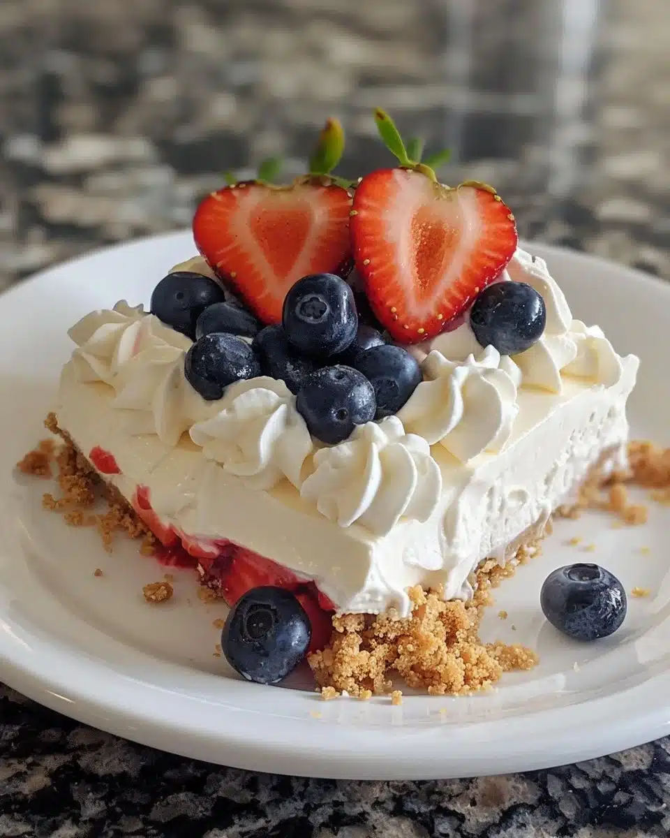 Delicious no-bake flag cheesecake bars topped with fresh berries.